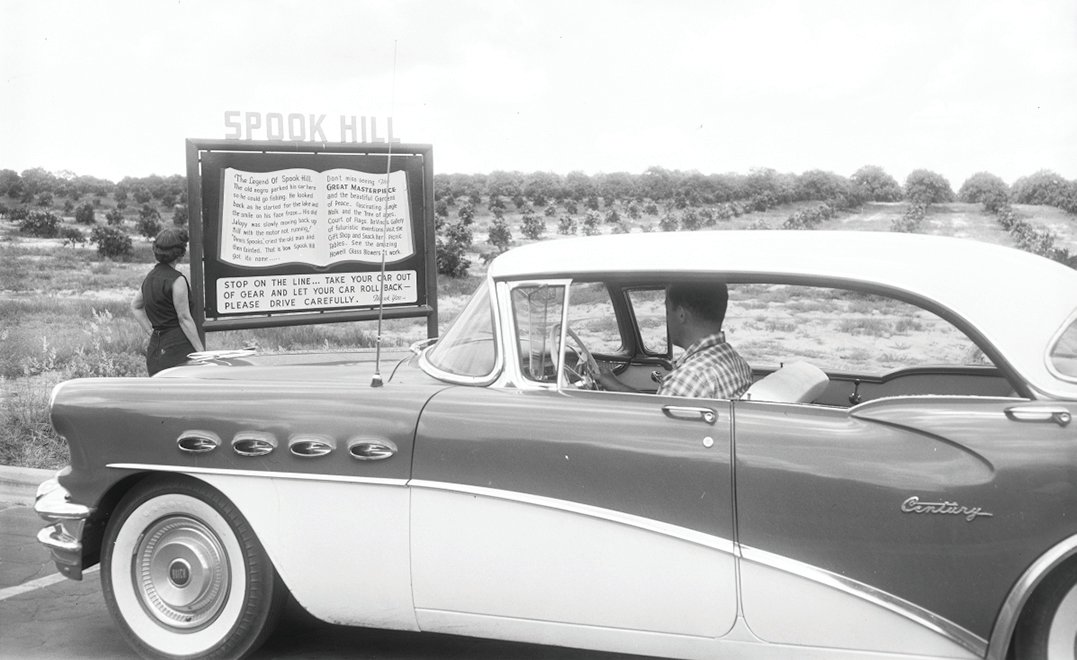 This 1956 photo shows a car stopped to check out Spook Hill.